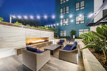 Elevated green space with outdoor fireplace and cozy seating